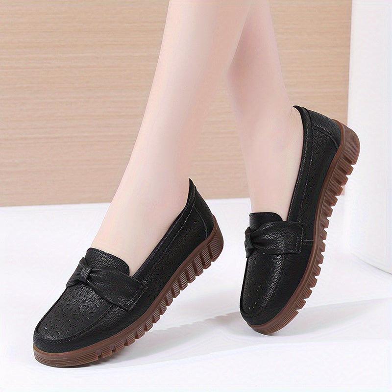 Flat loafers for women with hollow out design, bow detail, soft sole, suitable for casual walking.