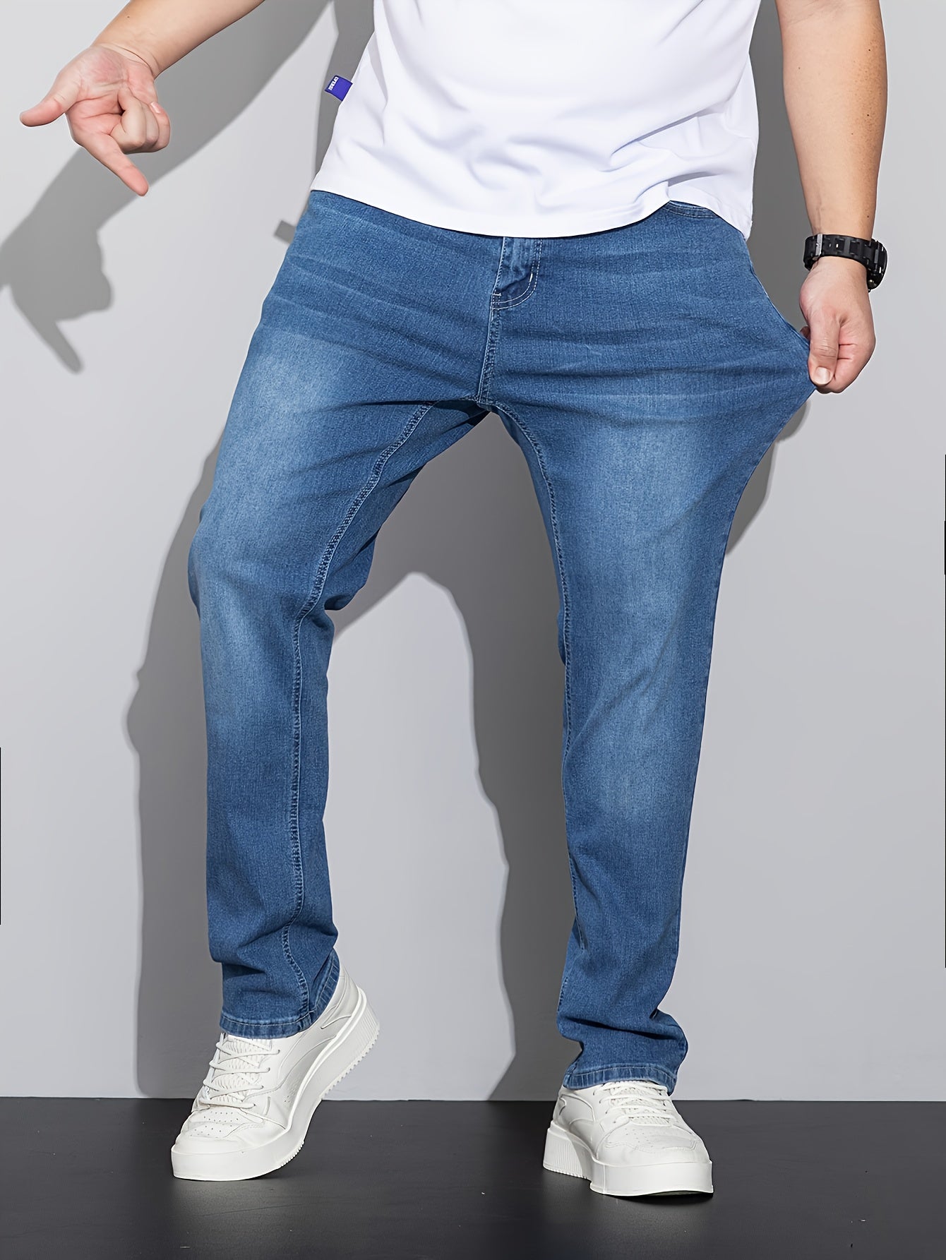 Stylish men's plus size denim pants for casual street style in spring and fall.