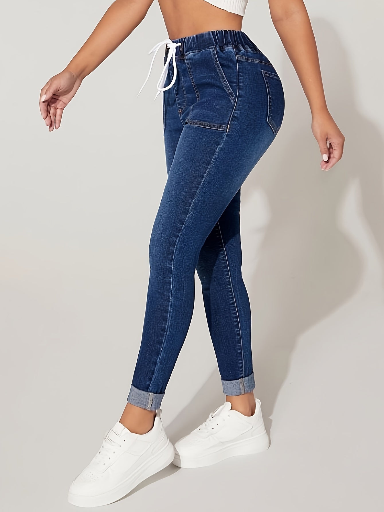 Plus size denim jeans for women with elastic drawstring waist and comfortable stretch fit.