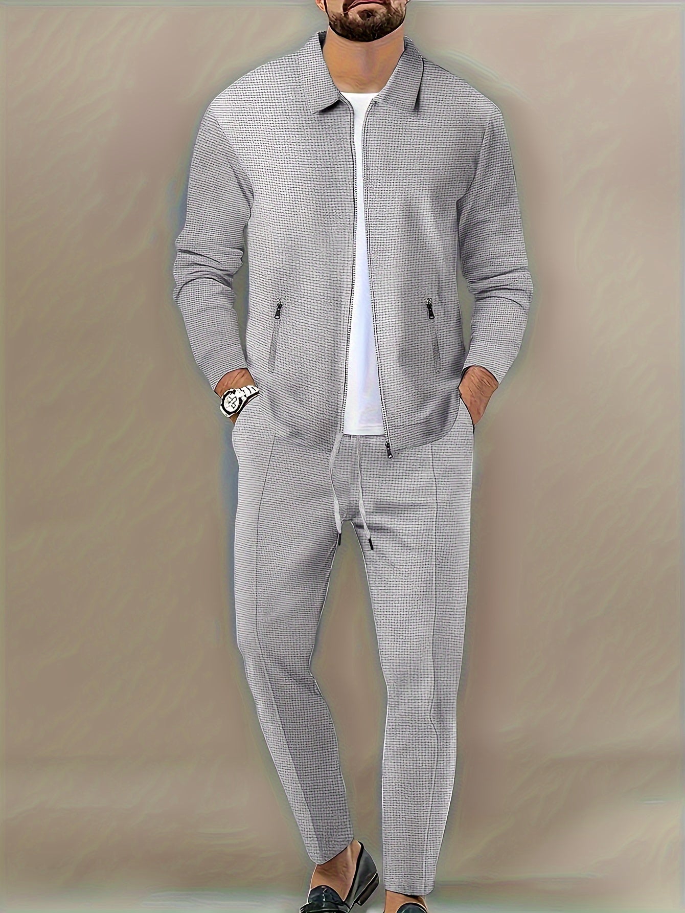 Polyester sports suit with waffle texture, casual lapel jacket and long pants set with zipper detail, solid color loose knit fabric, long sleeves, full polyester composition.