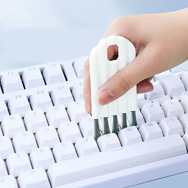 Multi-function keyboard cleaning kit with soft brush, duster, and keycap puller.