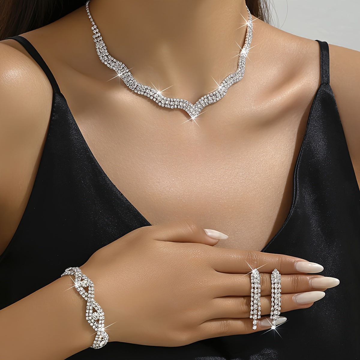 This elegant white jewelry set includes a stunning necklace, a pair of exquisite earrings, and a delicate bracelet, making it the perfect accessory for wedding parties and bridal gowns.