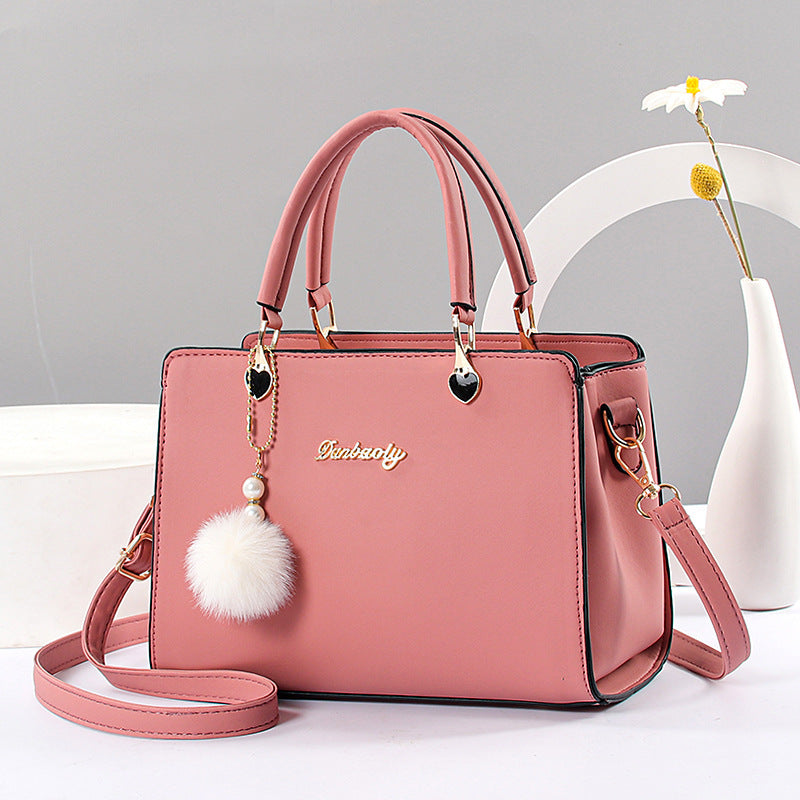 Women's stylish faux leather handbag with tassel embellishment, adjustable strap, zipper closure, and polyester lining. Available in multiple colors.