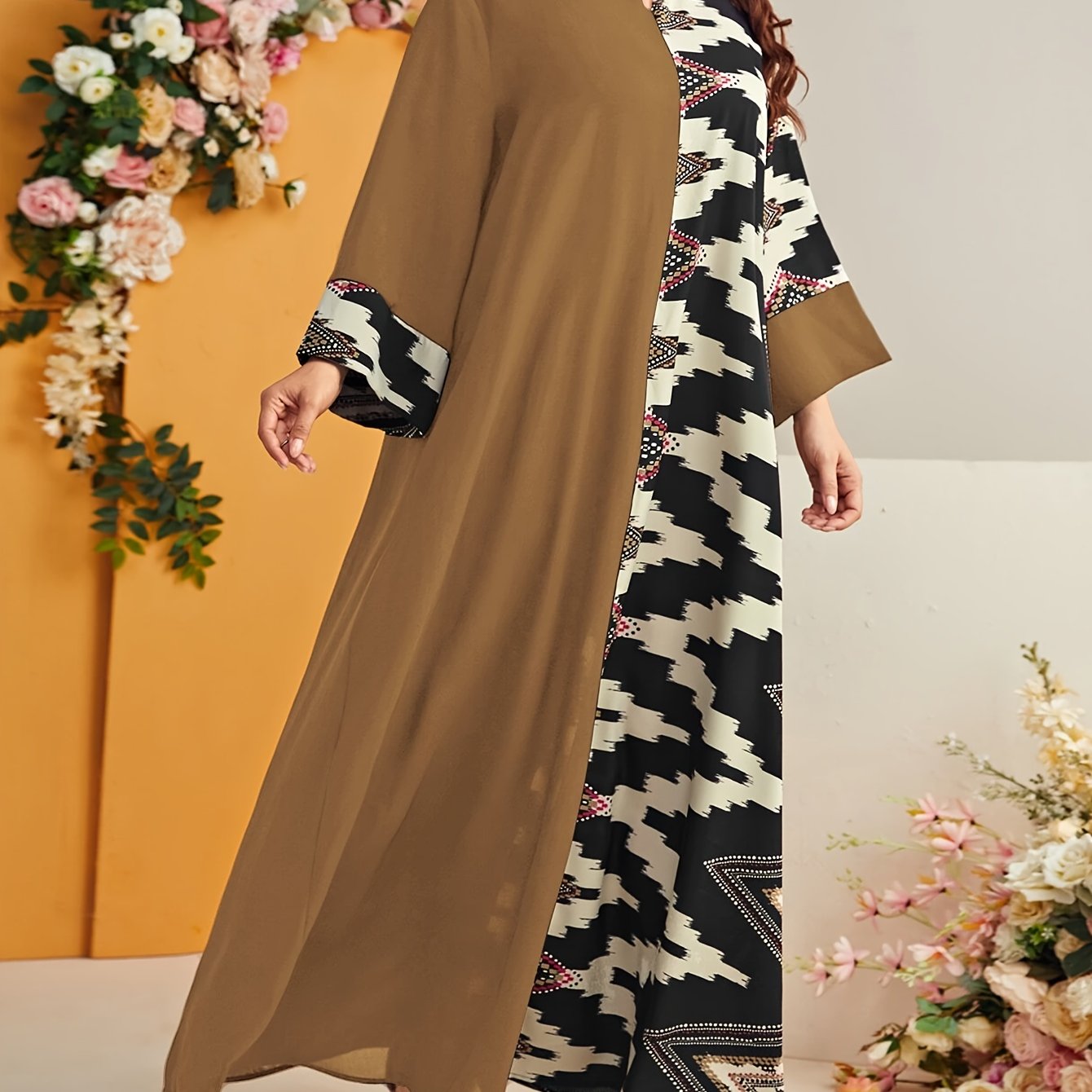 Elegant plus size geometric kaftan dress in black and beige houndstooth pattern with floral accents. Made of polyester, machine washable, with V-neck, long sleeves, and flowing silhouette