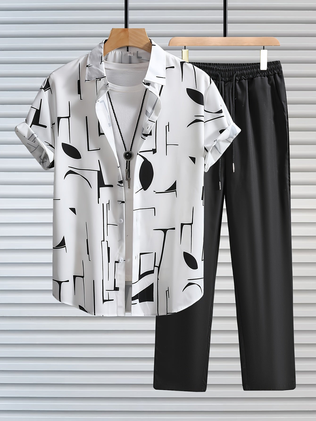 Casual geometric graphic print button-up shirt with lapels and short sleeves, paired with drawstring pants for outdoor activities.