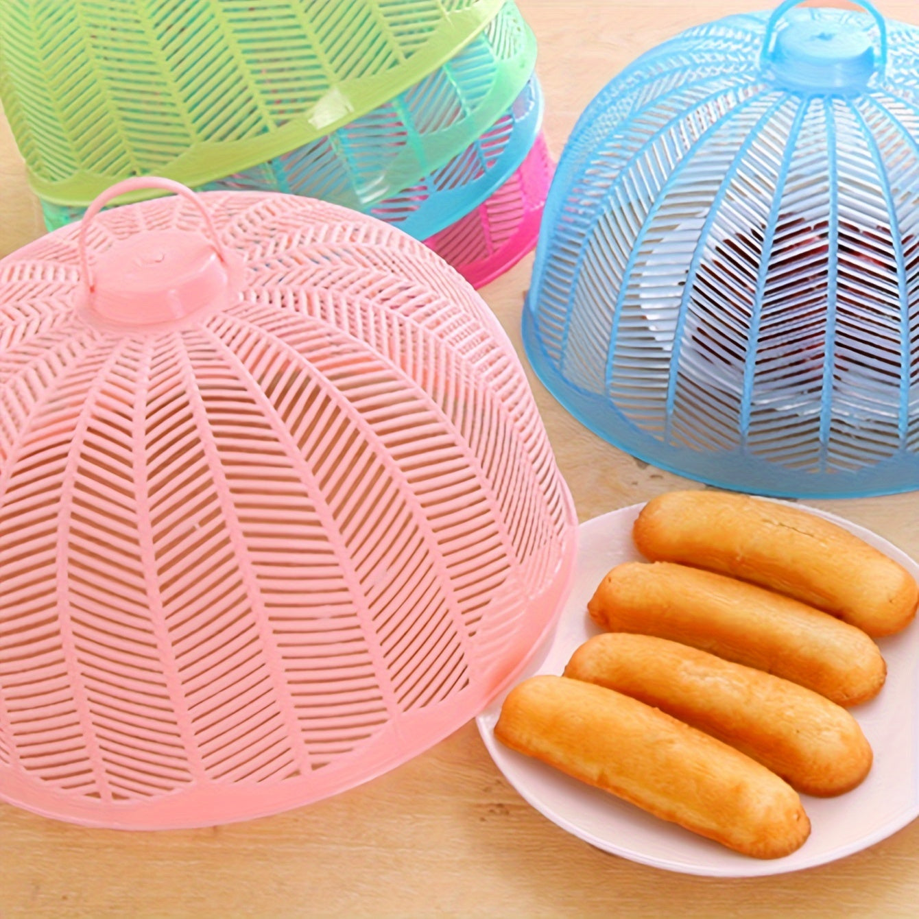 Set of 3 plastic food covers with colorful mesh screens for outdoor use. Keep flies, bugs, and dust away from your plates and bowls during picnics, parties, and in the kitchen.