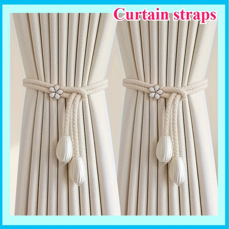 Two pieces of stylish adjustable curtain tiebacks with a modern floral buckle design and pearl accent. Made from polyester rope, these holders are perfect for adding an elegant touch to your window decor.