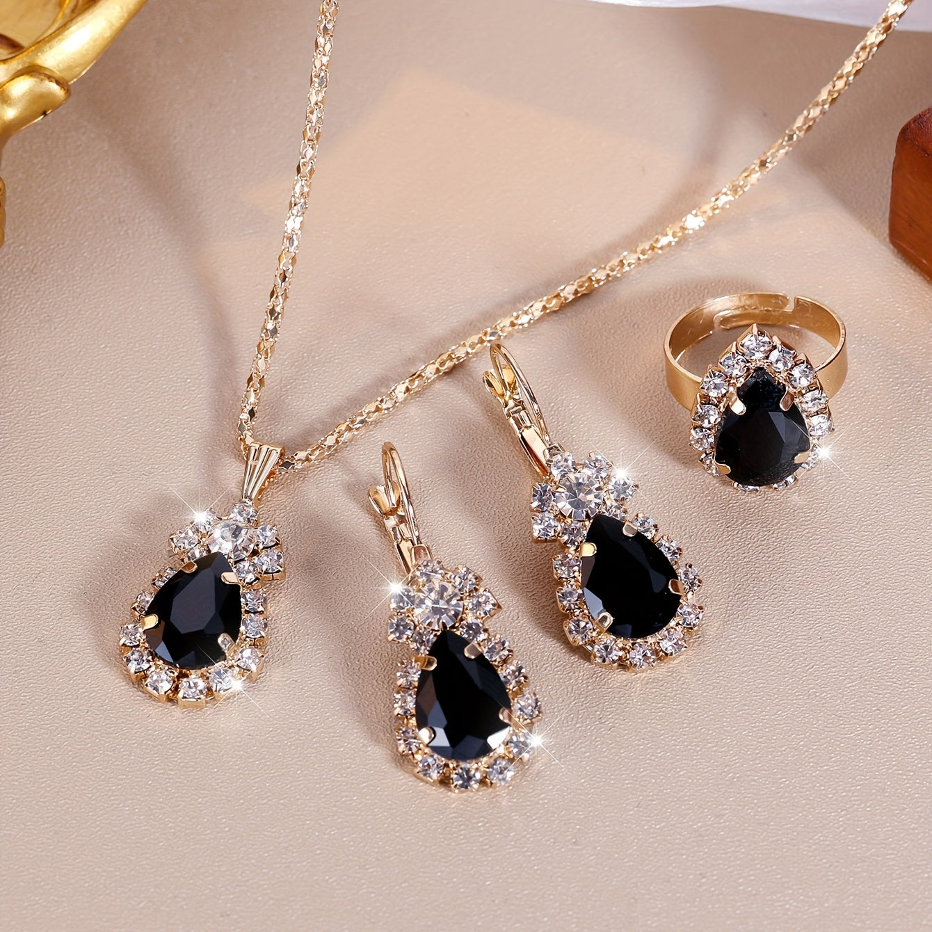 Complete your look with this elegant jewelry set featuring 4 pieces - earrings, necklace, and ring. Made with 18k gold plating and inlaid with shimmering zirconia in multiple colors to suit your style. Perfect for daily wear or adding a touch of glamour