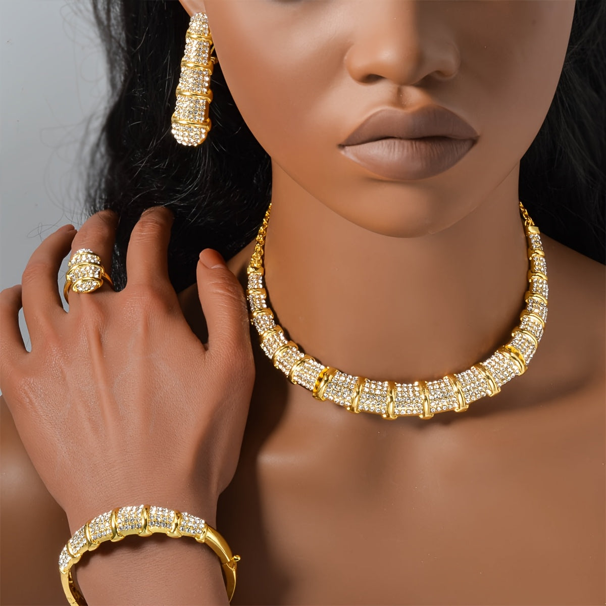 An elegant jewelry set designed for women, featuring a stunning bamboo-shaped necklace, bracelet, earrings, and ring. This four-piece set is perfect for sophisticated women attending weddings or as a luxurious holiday gift.