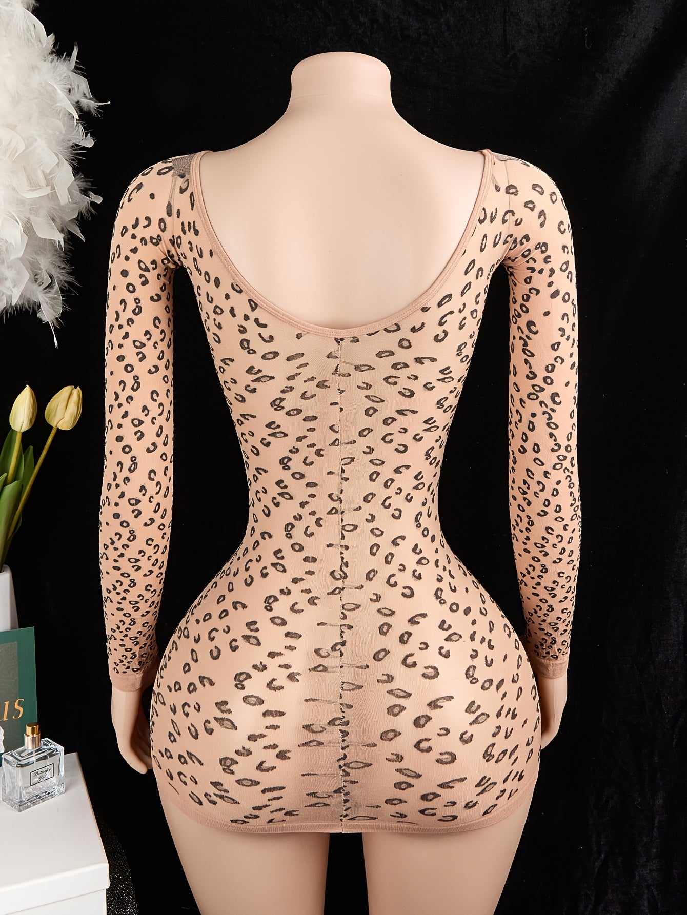 Leopard print bodycon bodysuit with long sleeves, backless design, and no padding. Made of 95% polyamide and 5% elastane. 100gsm lining. Adult size.