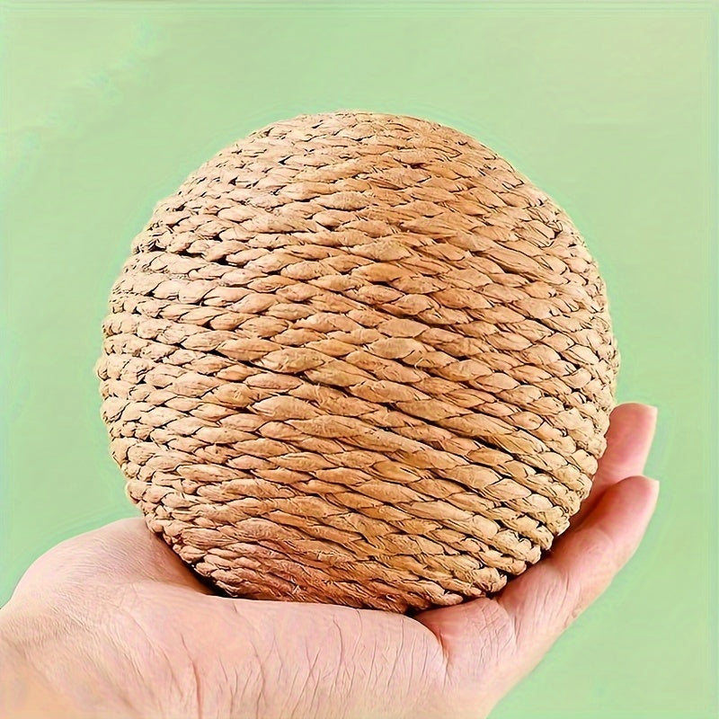 Interactive sound-making cat scratching ball toy made of cardboard material for cats to relieve play with their pet companion.