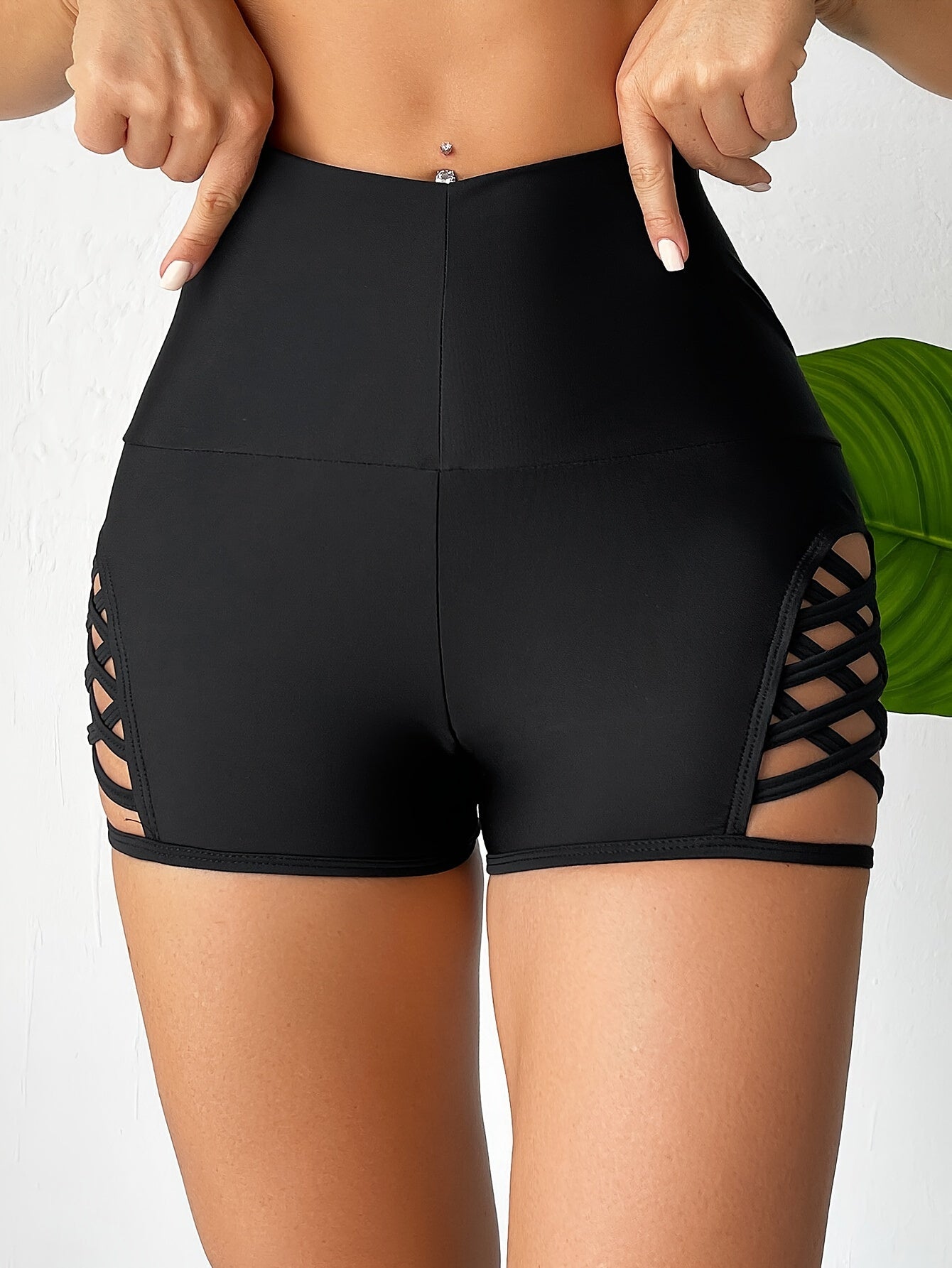 Women's high waist black boxer shorts with cut-out sides, perfect for beachwear.