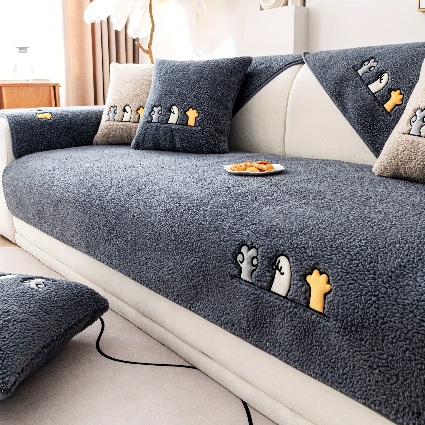 Modern plush sofa cover with paw pattern embroidery, non-slip protection for sofas, machine washable and suitable for various types of furniture.