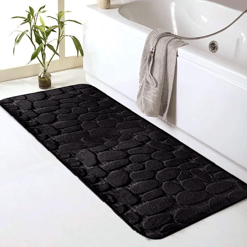 SoftTouch Cobblestone Pattern Memory Foam Bath Mat is machine washable and non-slip, making it a perfect addition to any bathroom. The absorbent polyester material resists stains, making it ideal for use in the bathtub or kitchen. This home decor runner