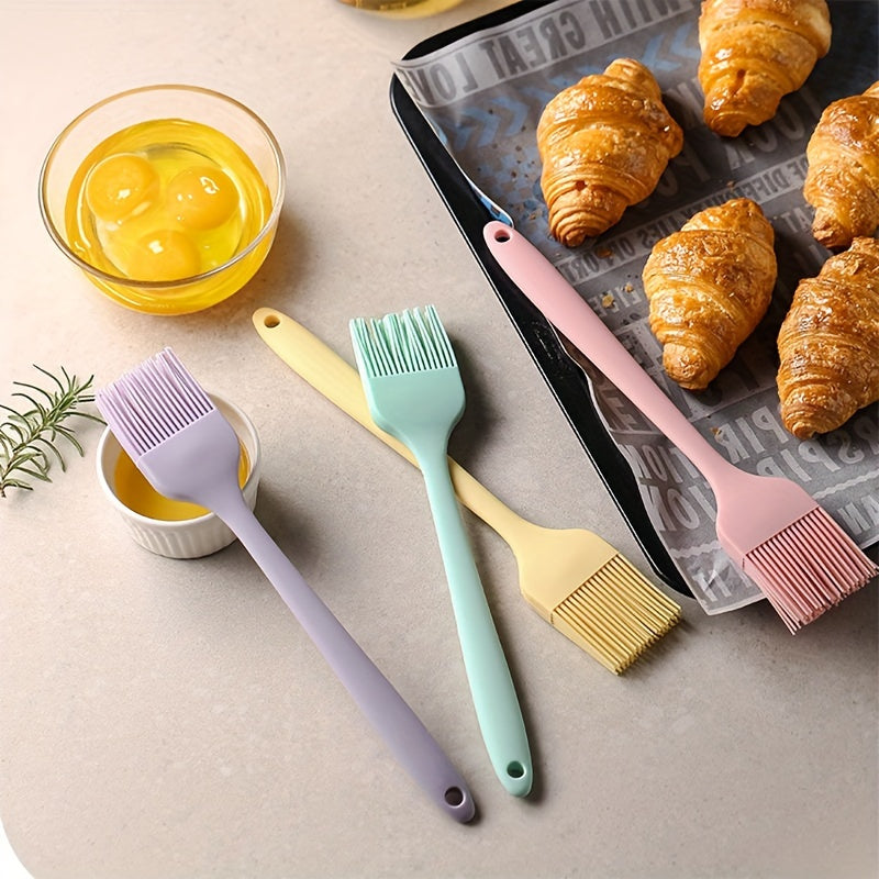 Set of 5-6 silicone spatulas, perfect for scraping cake cream and applying oil while baking. These tools are food-grade and also include a brush, making them essential kitchen gadgets and accessories.