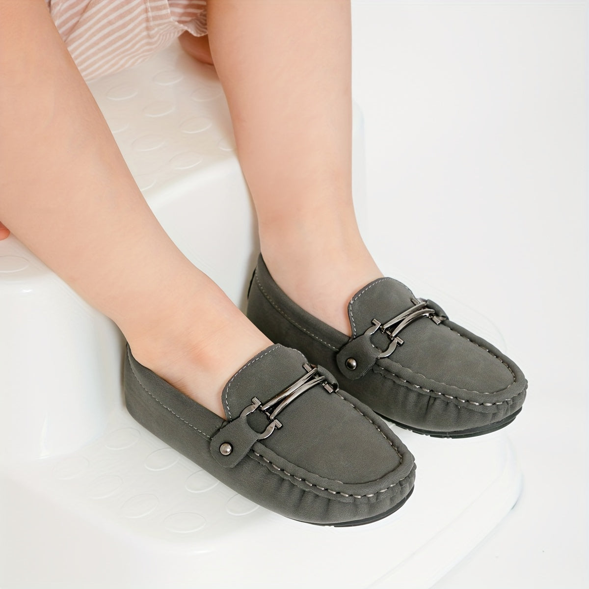 Boys' slip-on loafers in black and brown, suitable for all activities.