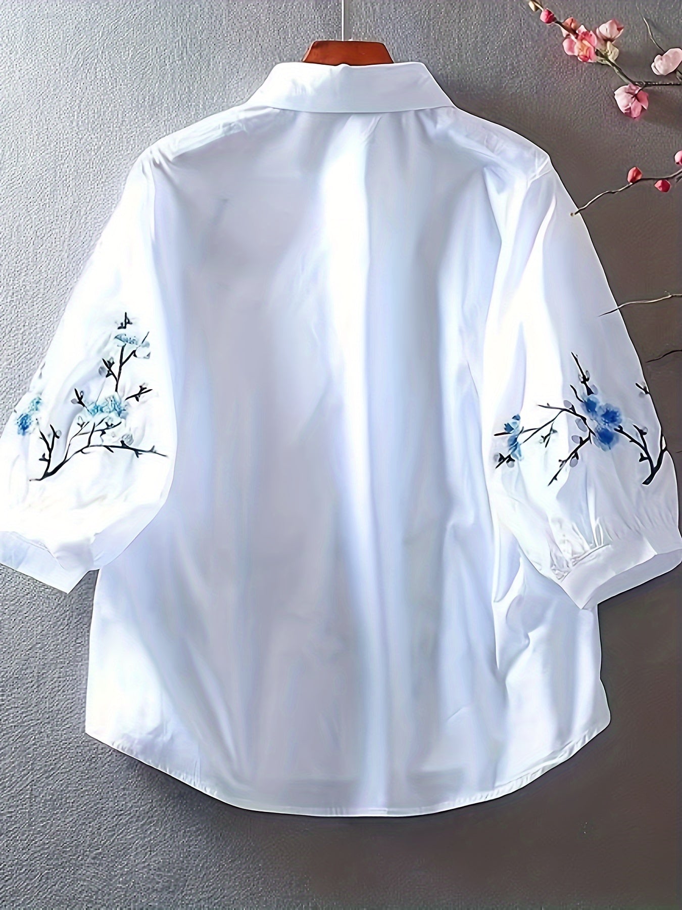 White floral embroidered shirt for women, made of polyester woven fabric with detailed embroidery and a collar design. Perfect for adult vacation style in spring/summer/autumn.