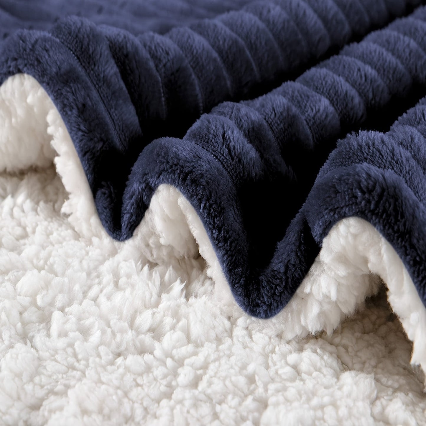 Soft and cozy reversible blanket in navy, perfect for infants, boys, and girls. This warm fleece blanket is thick and fuzzy with a sherpa lining, measuring 76.2cm x 101.6cm. A great gift idea!