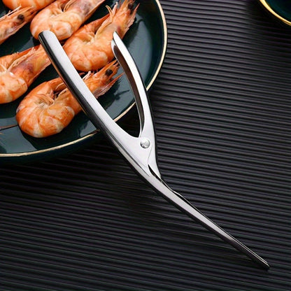 Effortlessly remove shrimp shells with this stainless steel deveiner peeler featuring a comfort grip handle. This kitchen utensil is designed for easy shrimp preparation and is made with food contact safe material.