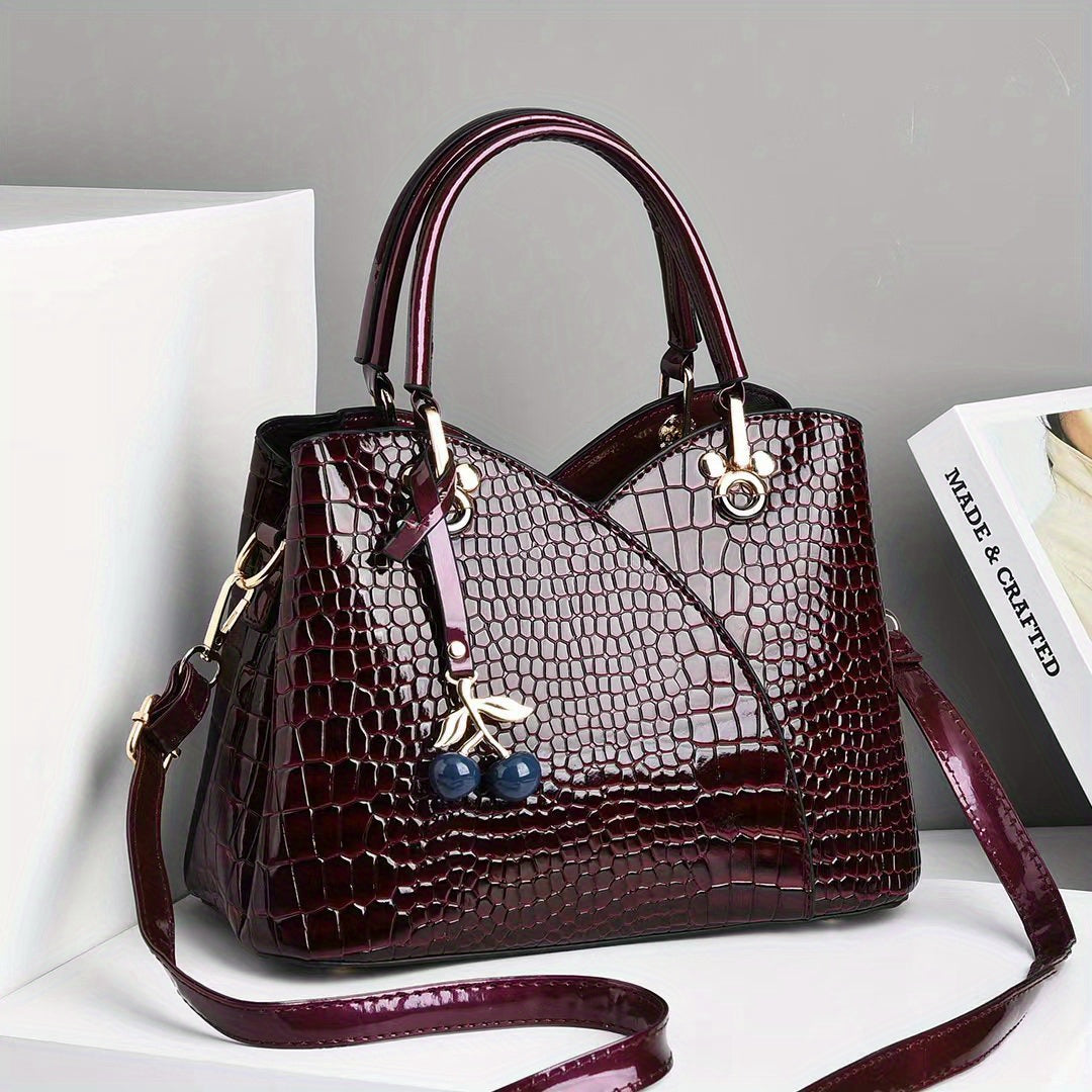 Stylish crocodile embossed tote bag with cherry pendant.