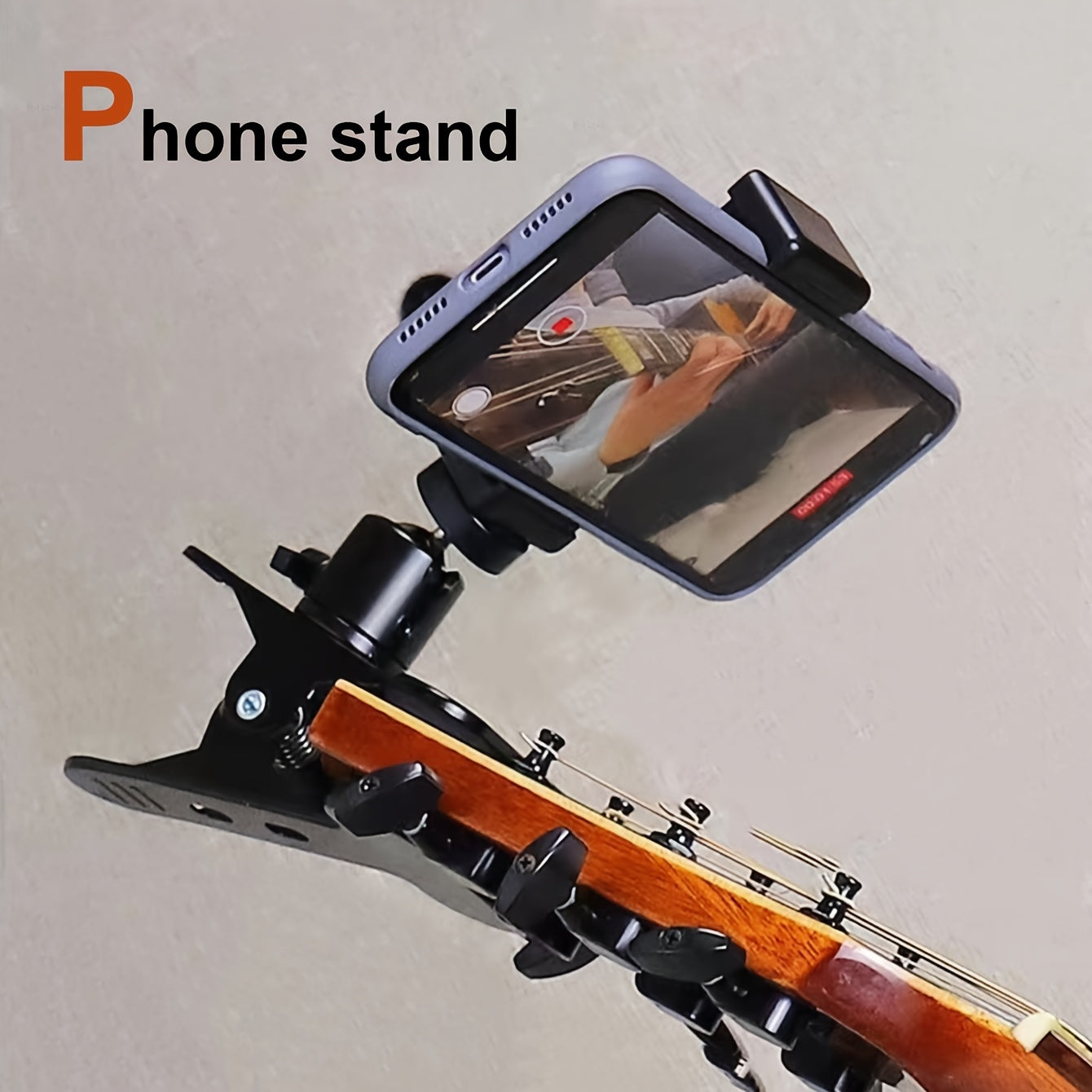 Black alloy cell phone clip for live streaming and recording musical instruments, doubles as a selfie holder.