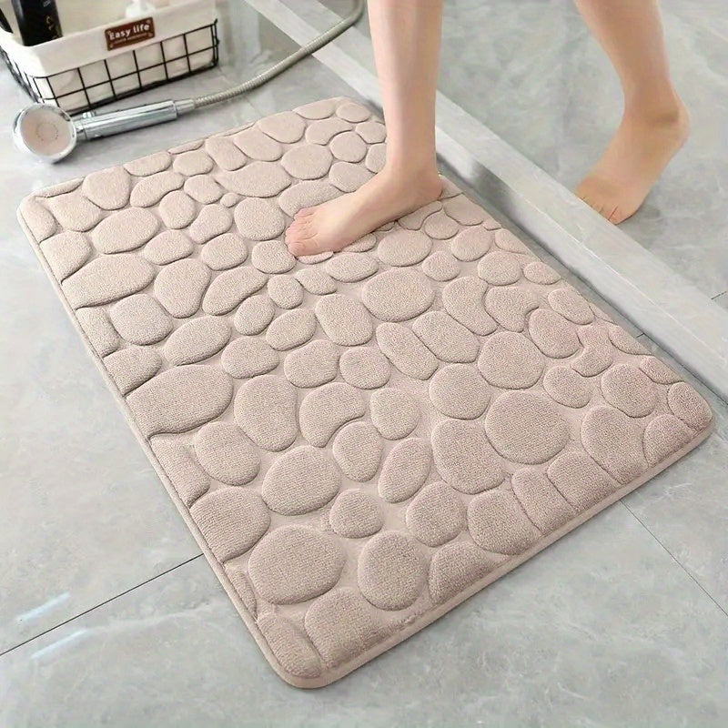 Soft, non-slip coral fleece bathroom mat in a pebble pattern. Quick-dry, machine washable, and low pile for comfort and home decor. Made of plush polyester fiber with knit fabric and 100% polyester material. 570gsm and 1.4cm thick.