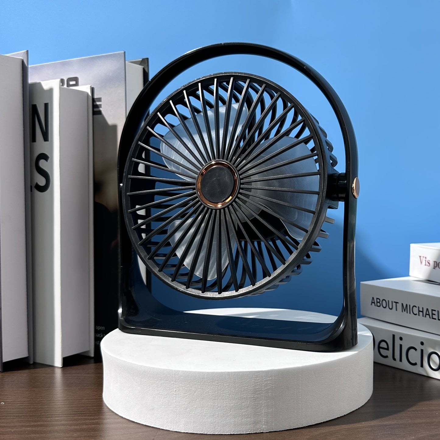 Stay cool anywhere with the JKUOO Portable USB Desk Fan. Featuring 5 speeds and 360° silent operation, this high-velocity fan is powered by a rechargeable lithium battery for indoor and outdoor use. Made of durable plastic, this table fan includes button