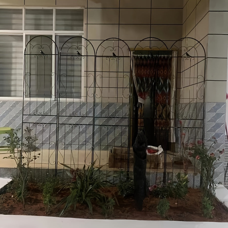 Outdoor iron trellis fence for climbing plants and flowers, ideal for decorating gardens.