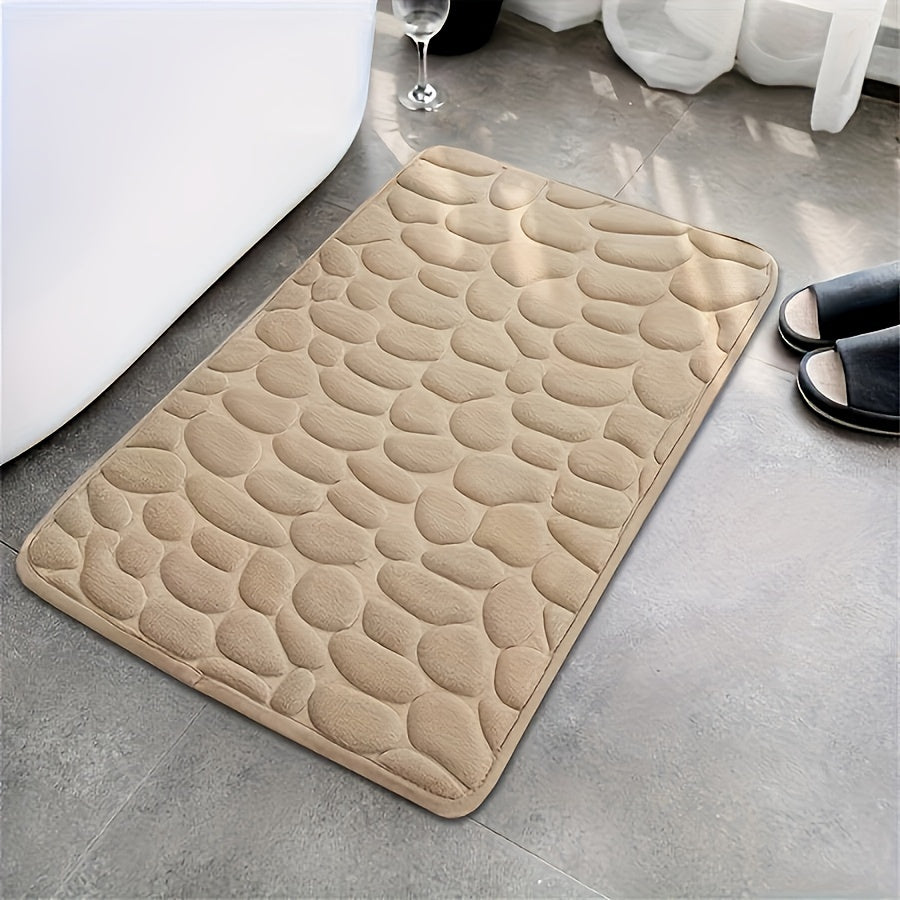 One piece of bath mat with embossed pebble pattern, highly absorbent and non-slip for bathroom use. Suitable for tub, toilet, and floor, made of machine washable polyester material. Dimensions are 59.94x39.88 cm.