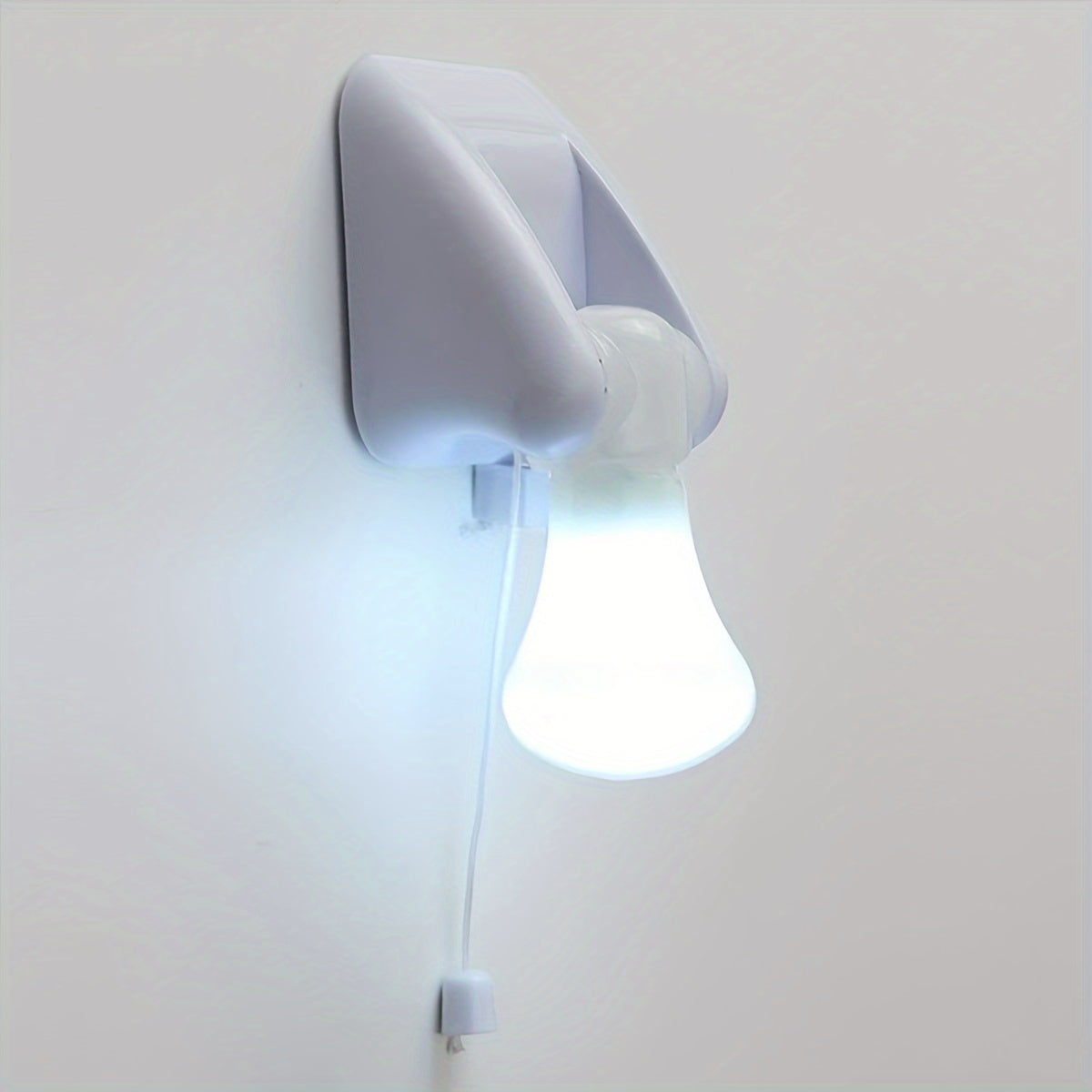 Small white LED night light; battery-powered with cordless design for bedside or cabinet; easy wall mount installation.