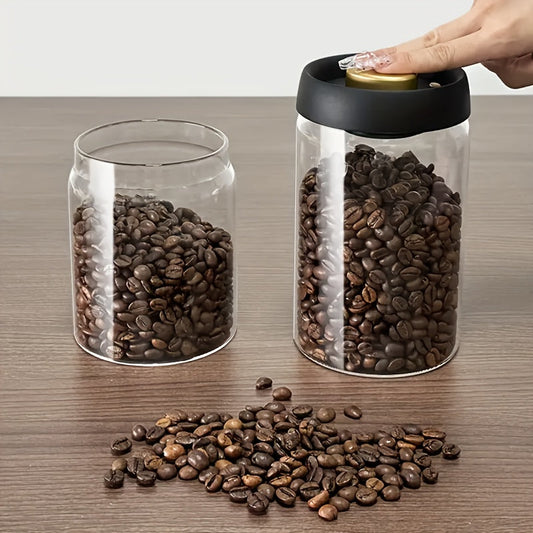 Glass storage jar with pressure pump, perfect for coffee beans, tea, nuts, and grains. Keeps food fresh and organized in the kitchen. Made of food-safe material.