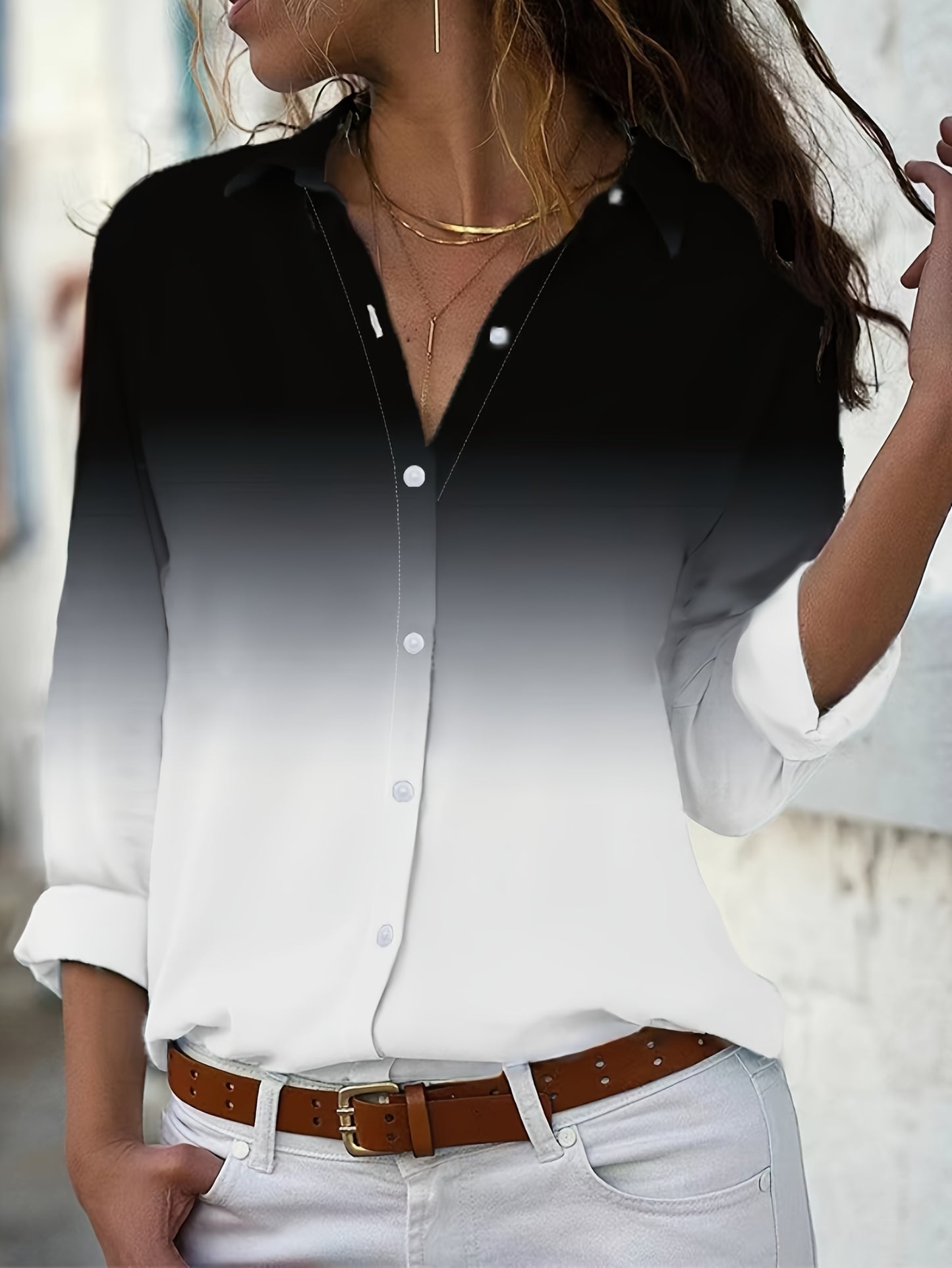 Stylish black and white ombre blouse with lapel collar, split sleeve, and flared hem. Made of 100% polyester, this long sleeve shirt is perfect for all seasons.