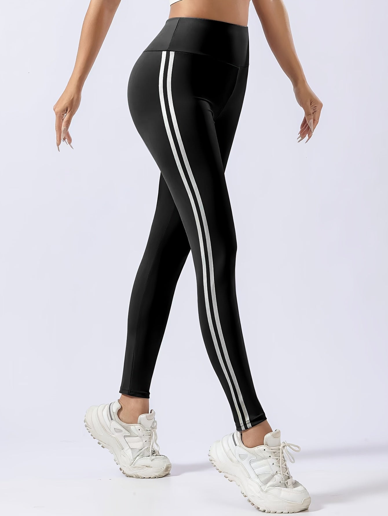 Women's chic black leggings with white side stripes, high-waist design, butt lifting, and tummy control features. Made with quick-dry and breathable fabric for a slimming effect. Machine