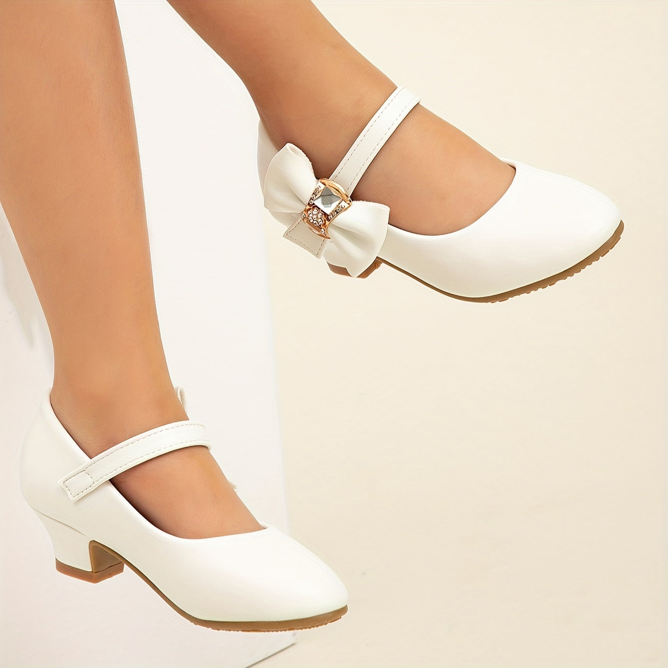 White princess shoes with bow, rhinestones, and high heels for girls' performances.