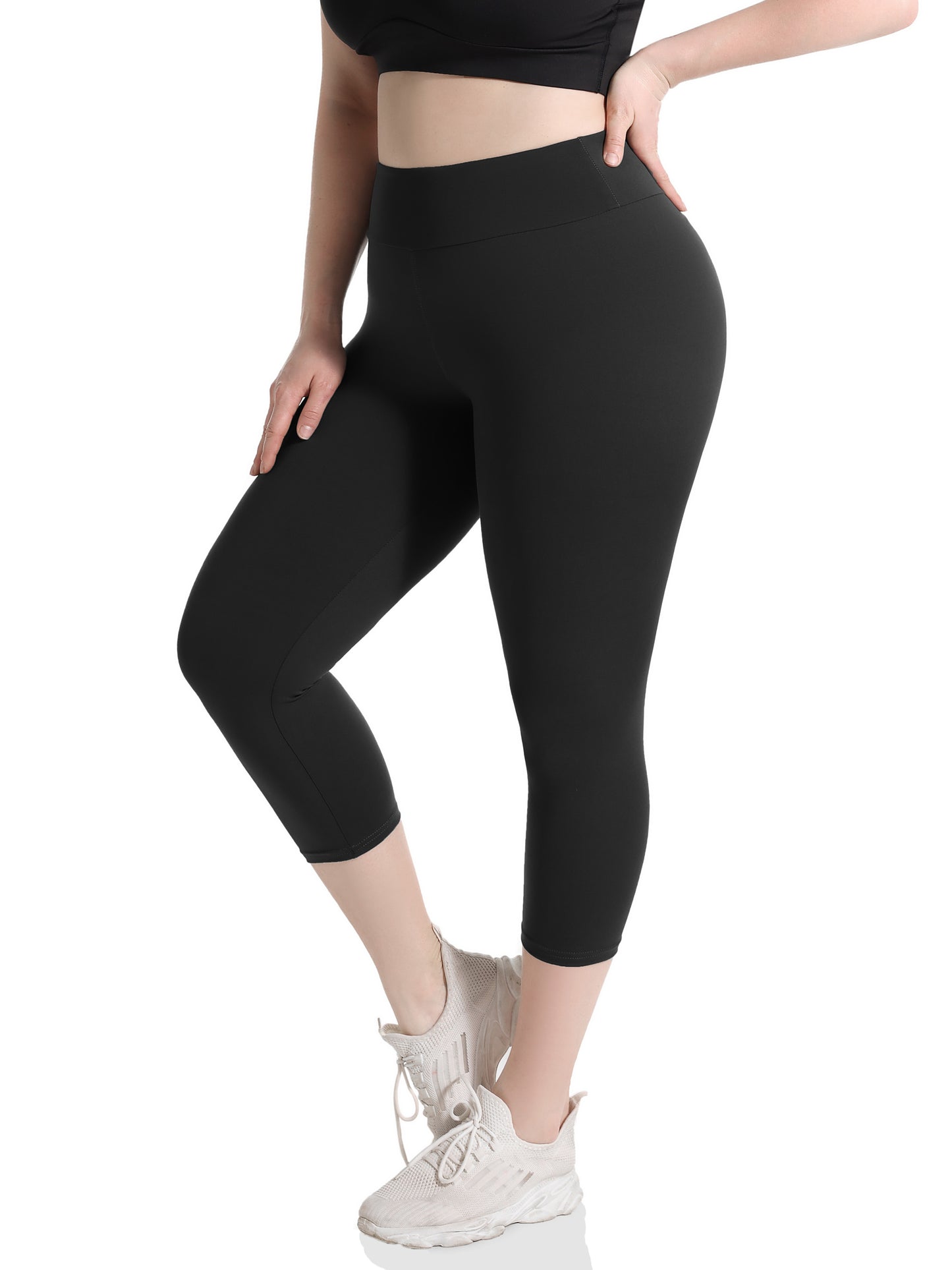 Plus size capri leggings for women, with high waist and tummy control. Features 4X stretch, pocket detail, and solid black color. Made from knit fabric, 92% polyester and 8% spandex