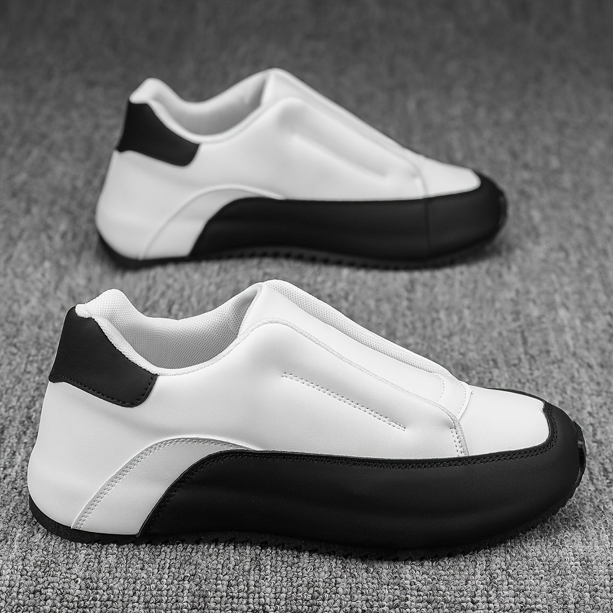 Men's slip-on casual sneakers in black & white with a thick sole, height boosting feature, round toe, and low-top design. Made with PU upper and fabric lining for versatility in all seasons.