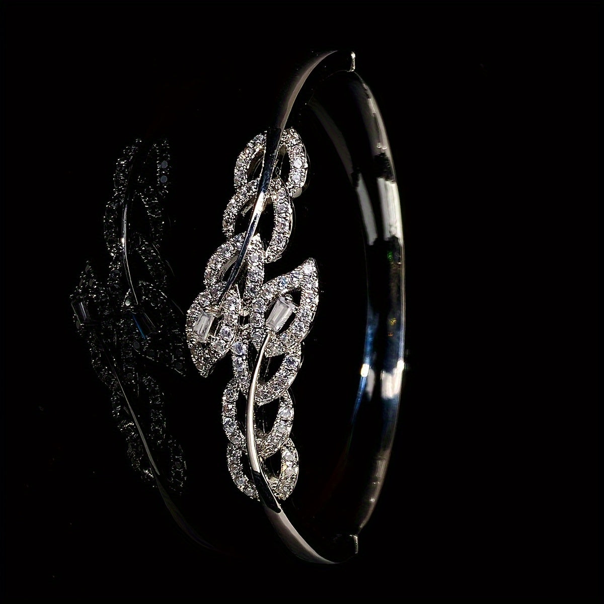 A high-end bracelet adorned with shiny leaf designs and micro-inlaid synthetic zirconia, adjustable for women, showcasing a unique and luxurious style.