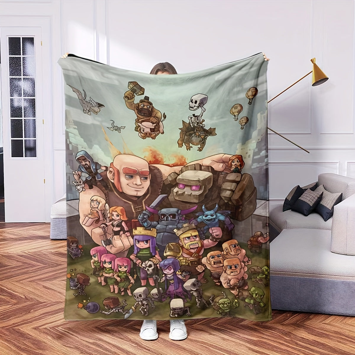 Flannel fleece blanket featuring Clash of Clans characters design, perfect for all seasons. This blanket is contemporary in style, machine washable, and made of polyester with anti-soil properties. The digital print design makes it suitable for gaming