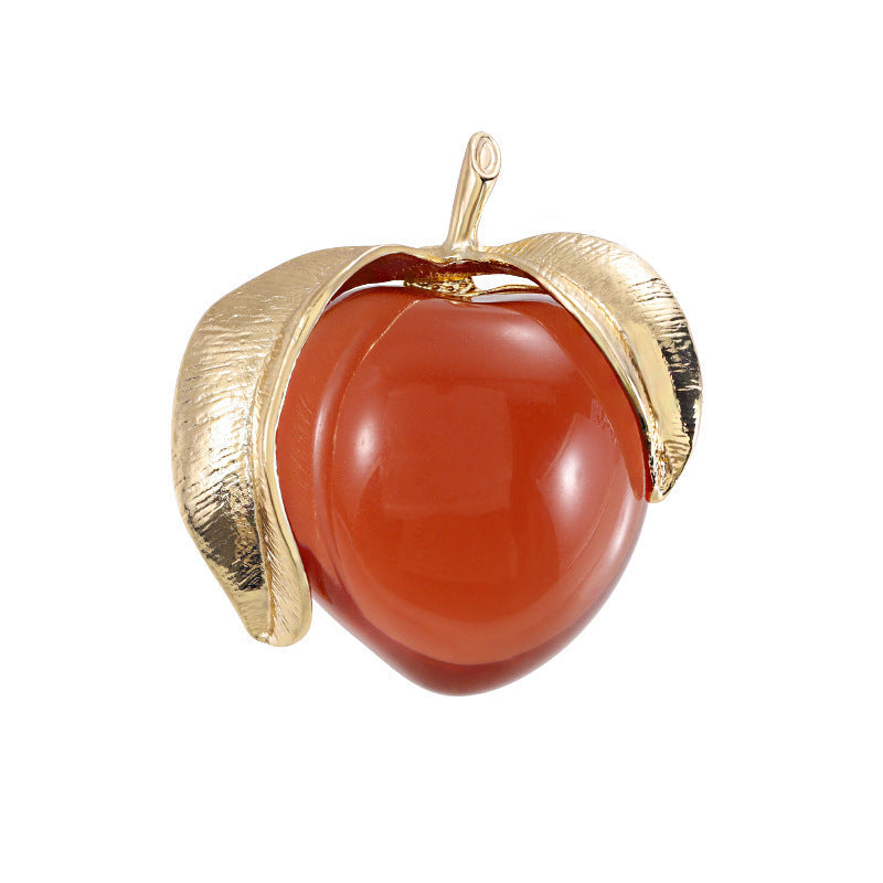 Vintage-inspired enamel brooch in a sophisticated peach design, featuring a high-end transparent finish. This fashionable fruit-shaped pin is a stylish accessory for clothing and suits.