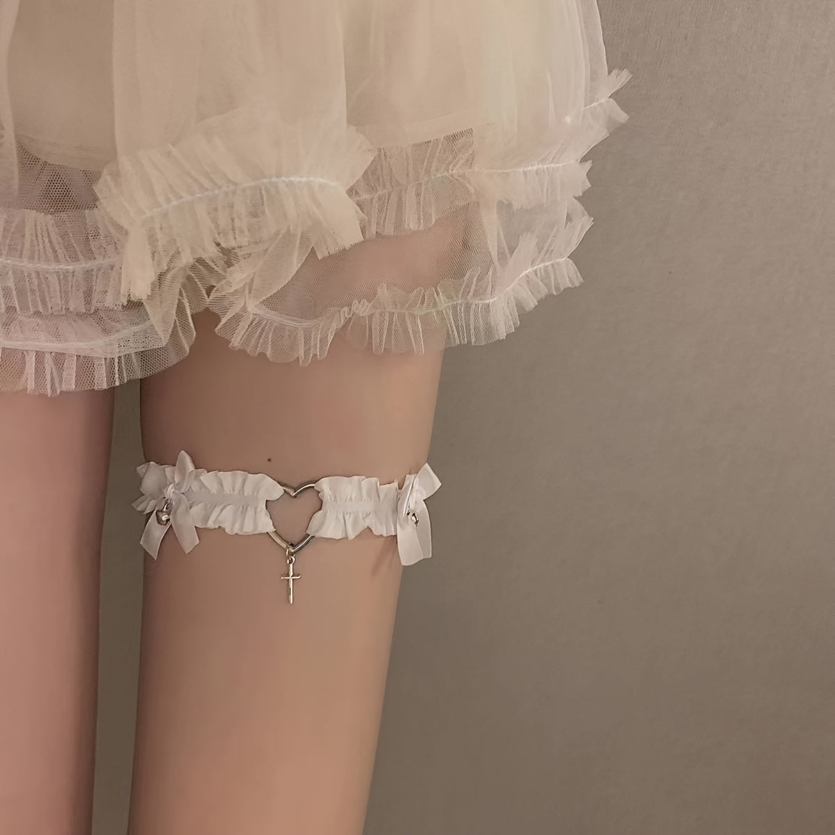 Heart-shaped ring choker, frilled leg garter, lingerie, and erotic accessories.