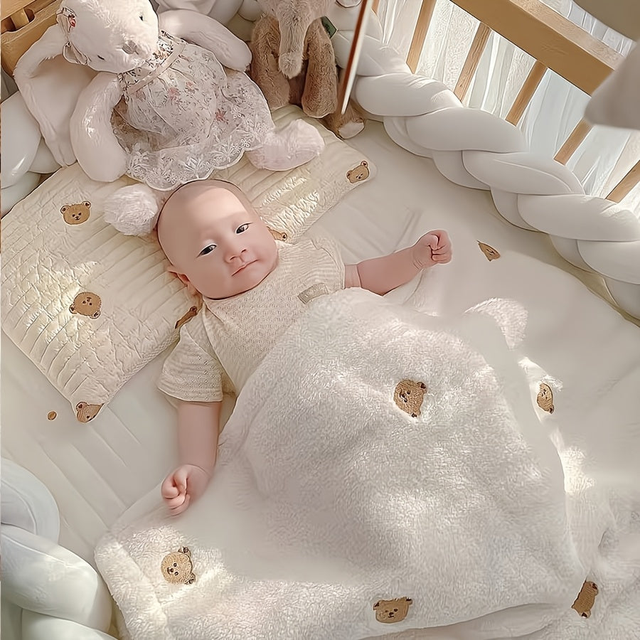 Soft polyester white blanket featuring an embroidered bear design, perfect for cozy youngsters.