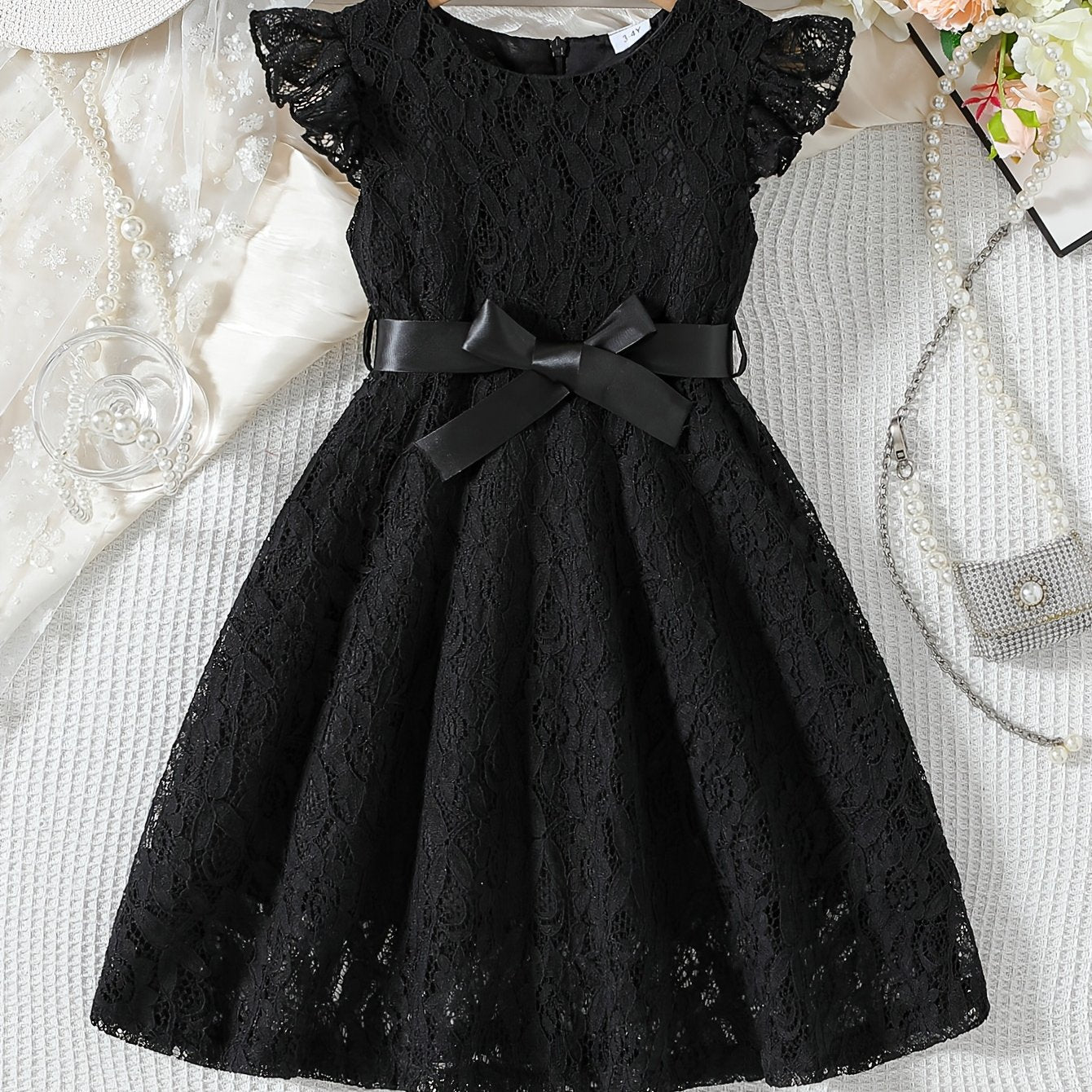 Girls' spring/summer dress with lace detail, belt, and flutter sleeves, ideal for daily wear or birthday parties.