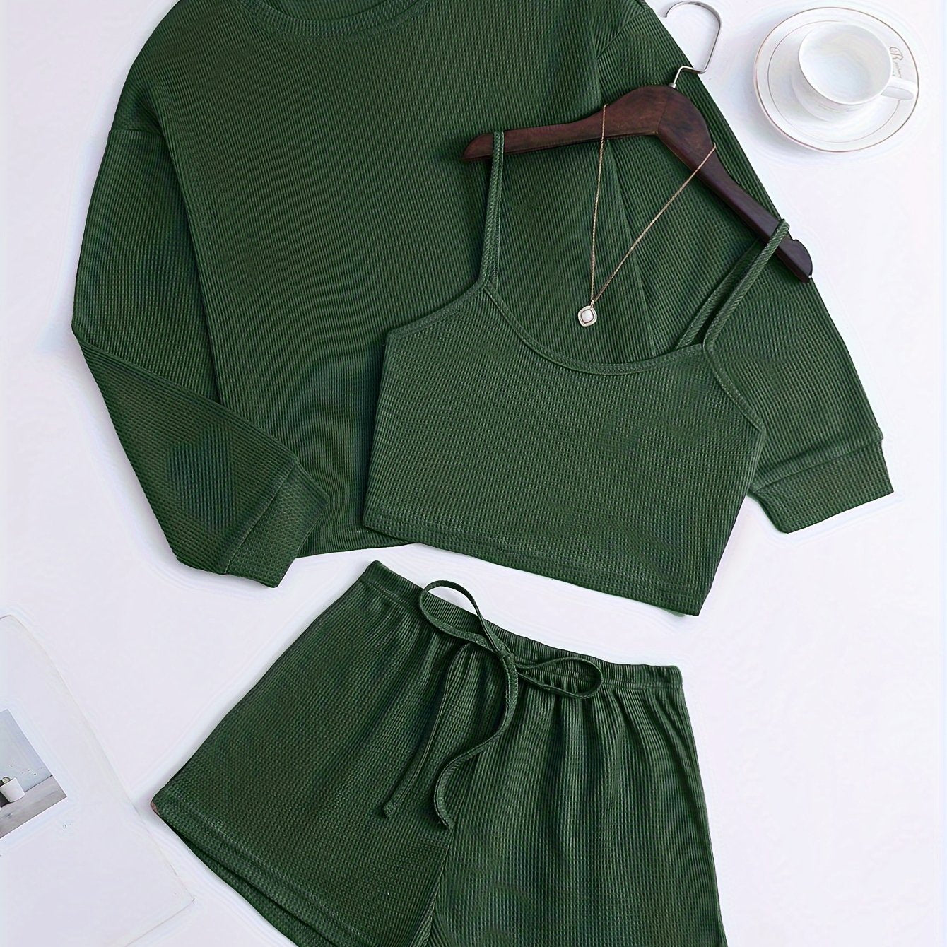 Women's loungewear set with waffle texture, long sleeve top, crop cami, and elastic shorts.