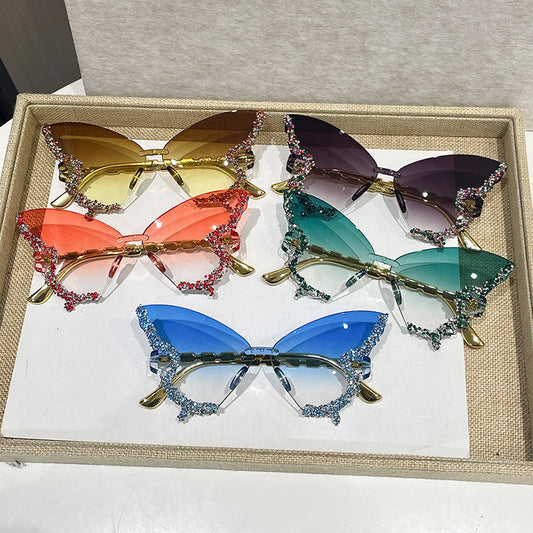 Fashionable butterfly-shaped rimless glasses with rhinestone accents and large frames, featuring anti-reflective polycarbonate lenses for women. Perfect for parties, fashion shows, and