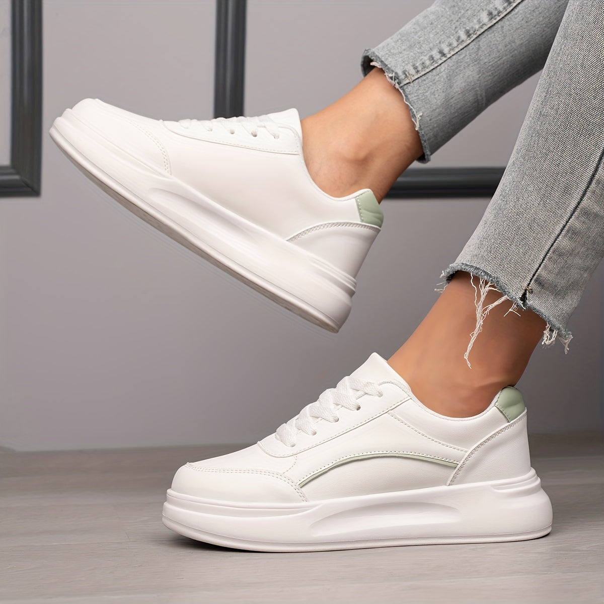 Women's white skate shoes with round toe, lace up closure, and low top flat design. Comfortable for casual wear and sports.