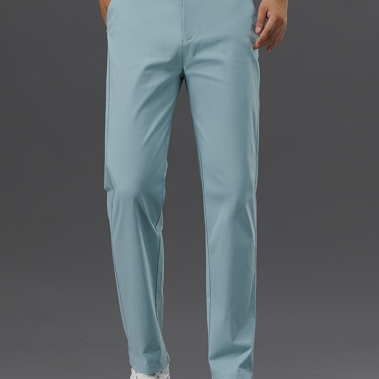 Men's slim-fit cotton blend trousers in solid color, suitable for business casual wear throughout the year. Features micro-elastic fabric, pockets, and regular length.