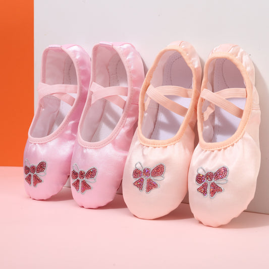 Girls’ ballet dance shoes with sparkling sequin and embroidered bow detail, soft sole, breathable canvas slip-ons. Available in pink and peach.