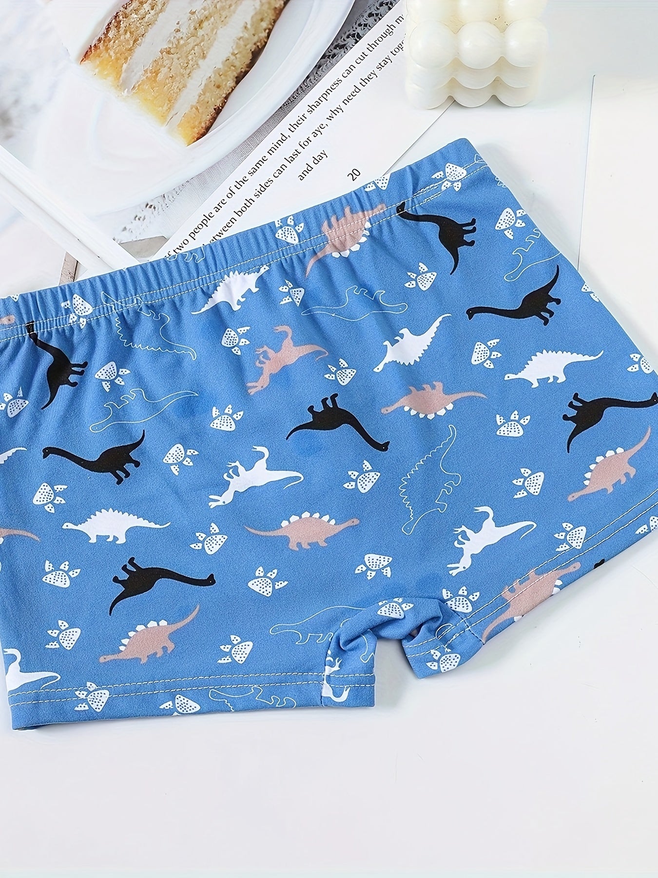 Boys' 3-pack soft cotton blend boxer briefs with cartoon dinosaur patterns. Comfortable and breathable for everyday wear. Casual style with elastic waistband.