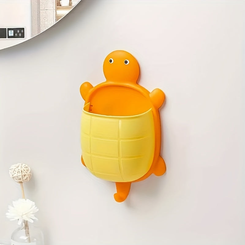 Turtle-shaped wall-mounted remote control holder with self-adhesive storage for home bathroom makeup organization.