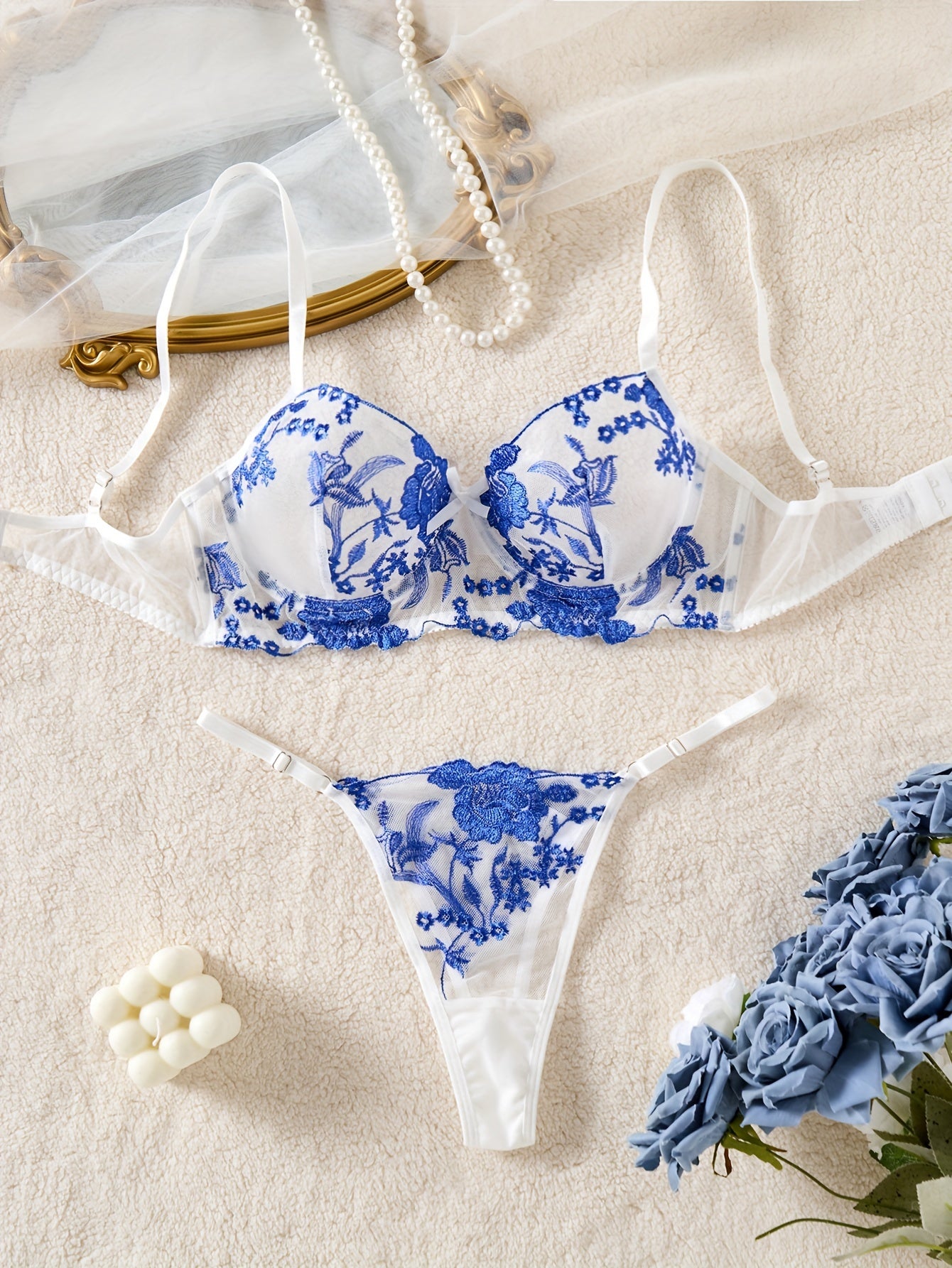 Blue floral embroidered lingerie set with medium support bra and matching thong. Perfect for parties, drop waist style in knit fabric.